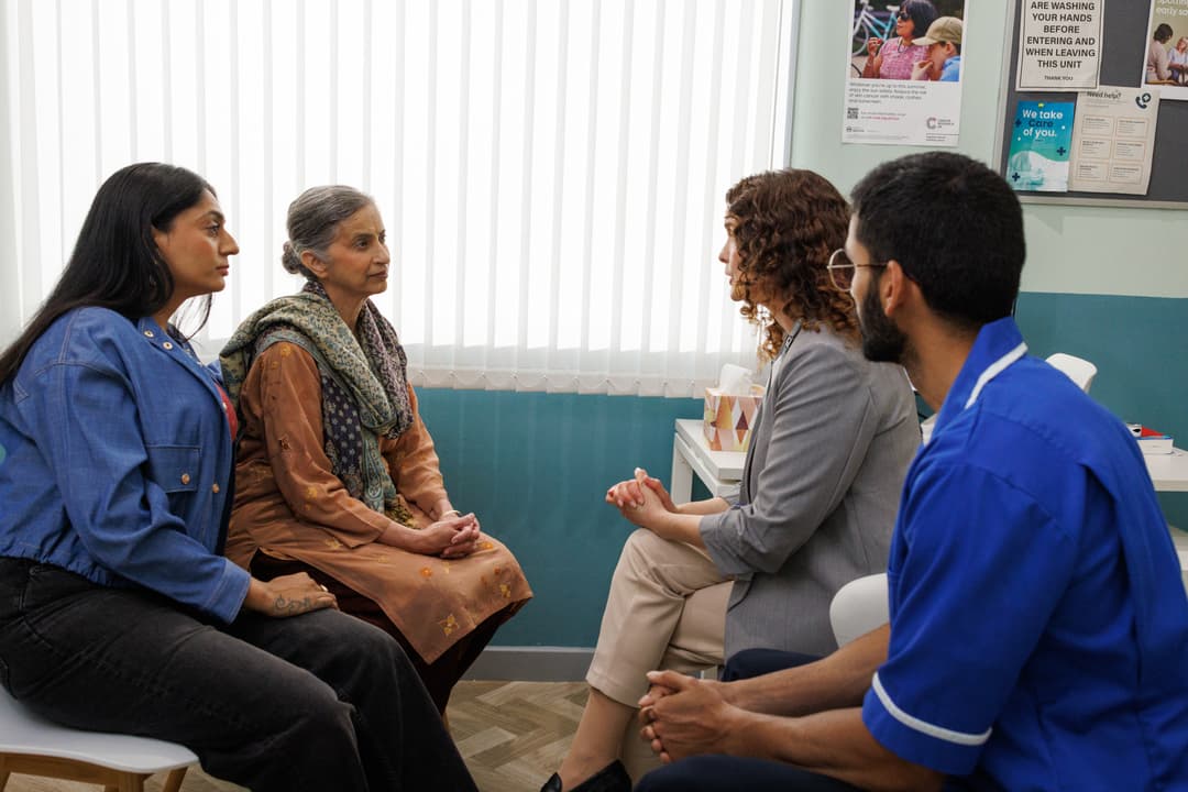 Doctors speaking to the patient and her carer.
