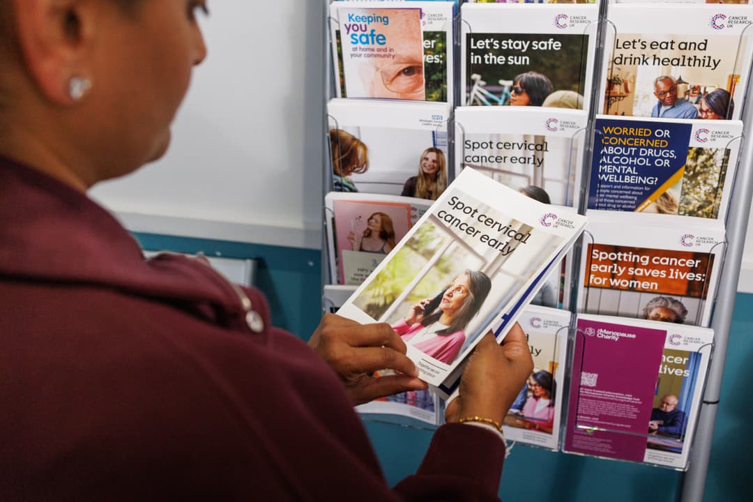 Person looking at the early detection guide for cervical cancer.