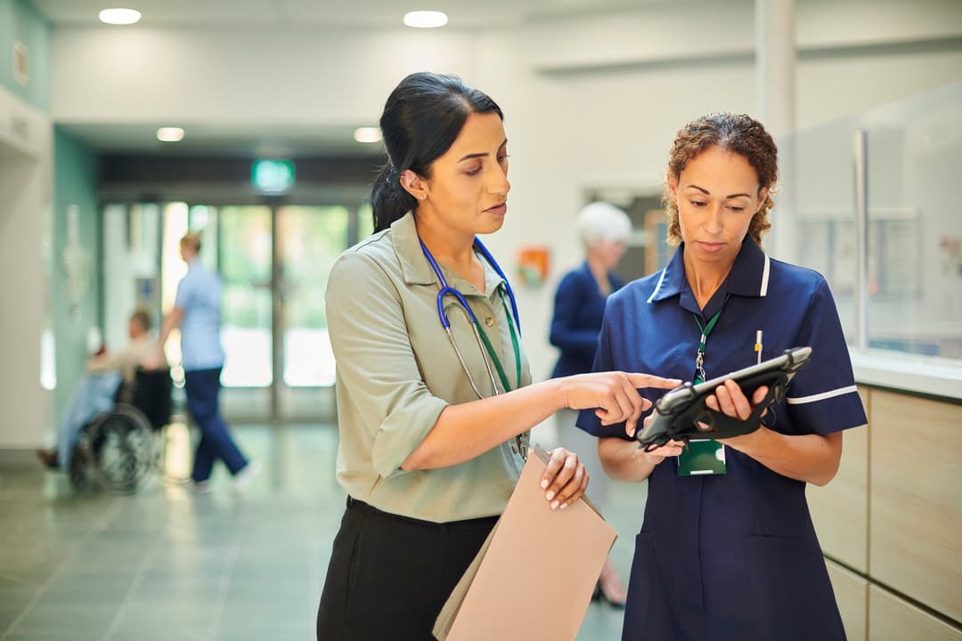 A doctor and nurse looking at a chart.