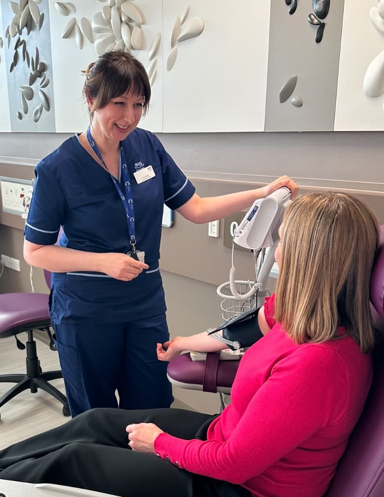 Research Nurse talking with patient.
