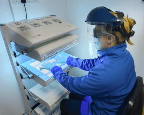 A photo of an ultraviolet light machine for the hands.